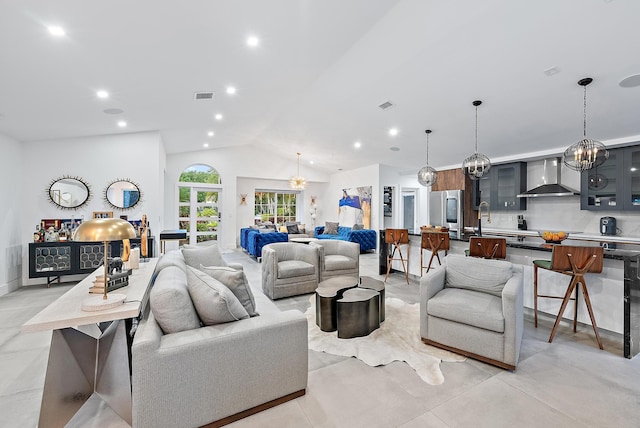 living area featuring recessed lighting, vaulted ceiling, an inviting chandelier, and visible vents