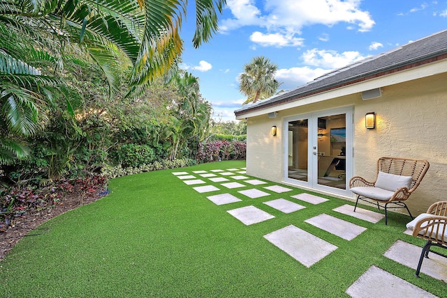 view of yard featuring french doors and a patio area