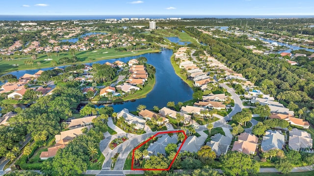 drone / aerial view with a residential view, a water view, and golf course view