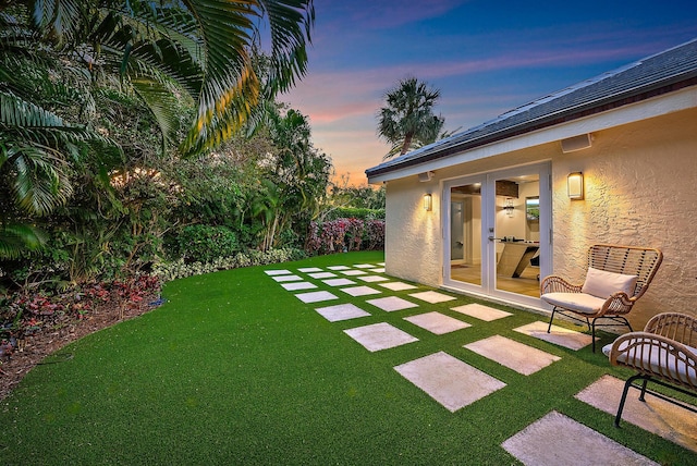 view of yard with a patio and french doors