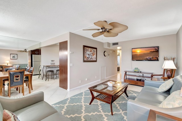 4049 Wolverton C, Boca Raton, FL 33434 - living room featuring ceiling fan, light tile patterned floors, and a textured ceiling