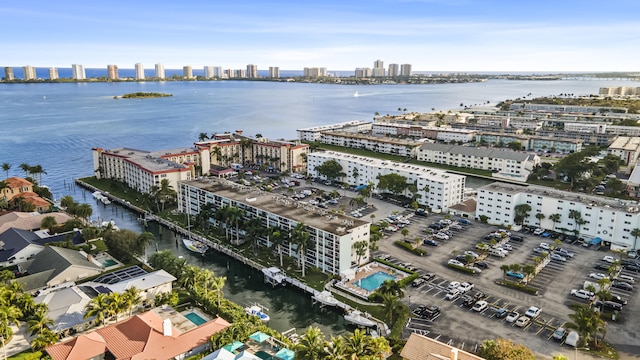 birds eye view of property featuring a water view and a city view