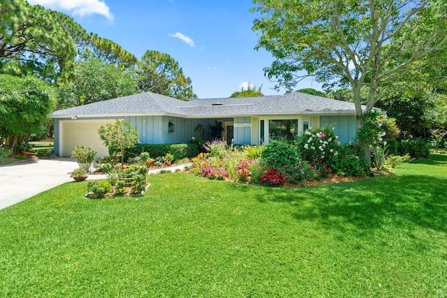 single story home featuring driveway, a shingled roof, a front yard, and a garage
