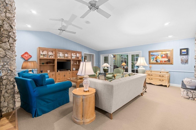 carpeted living area with ceiling fan and vaulted ceiling