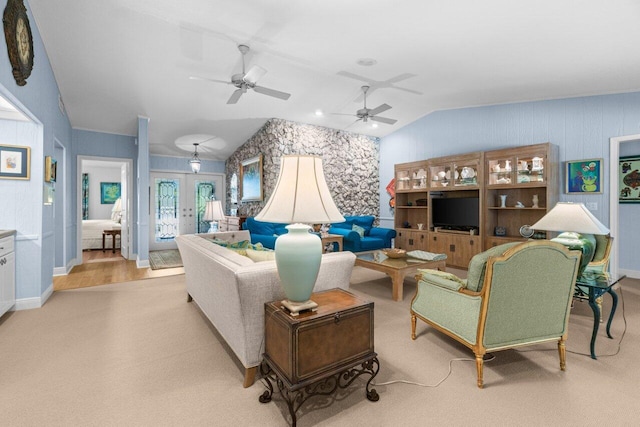 living room with vaulted ceiling, a ceiling fan, french doors, and light carpet