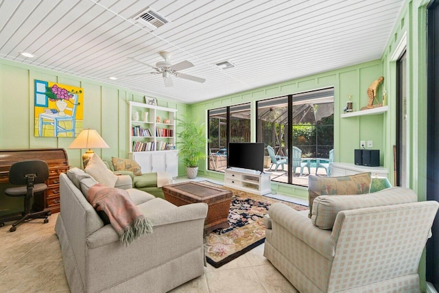 living area with tile patterned flooring, ceiling fan, and visible vents