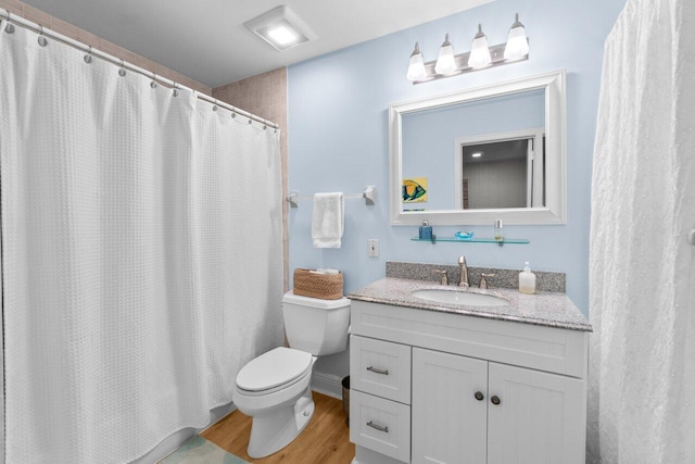 full bath with toilet, curtained shower, wood finished floors, and vanity