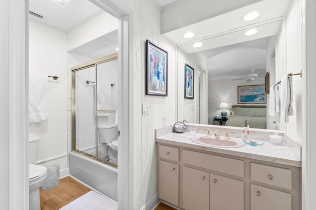 ensuite bathroom featuring vanity, visible vents, wood finished floors, toilet, and connected bathroom