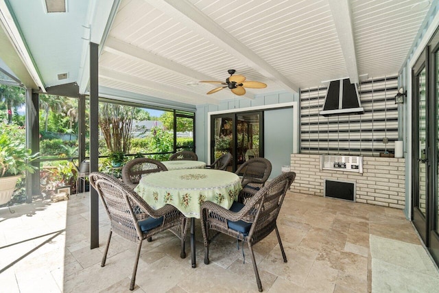 sunroom / solarium with french doors, beamed ceiling, a ceiling fan, and outdoor dining area