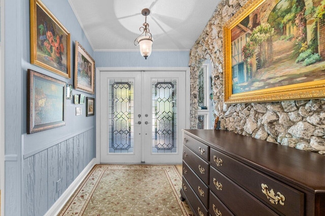 foyer entrance featuring wainscoting and french doors
