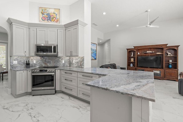 3352 SE Cascadia Way, Hobe Sound, FL 33455 - kitchen with stainless steel appliances, marble finish floor, and a peninsula