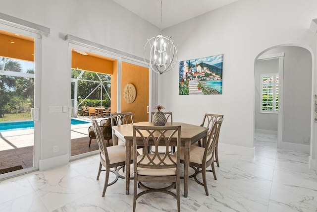3352 SE Cascadia Way, Hobe Sound, FL 33455 - dining space with arched walkways, baseboards, plenty of natural light, and marble finish floor