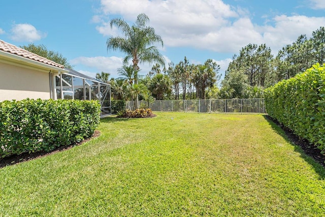 3352 SE Cascadia Way, Hobe Sound, FL 33455 - view of yard featuring a fenced backyard and glass enclosure