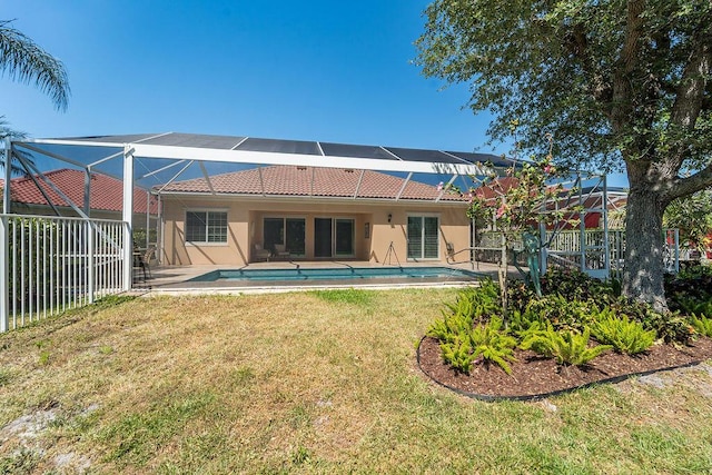 3352 SE Cascadia Way, Hobe Sound, FL 33455 - rear view of house with an outdoor pool, stucco siding, glass enclosure, a yard, and a tile roof