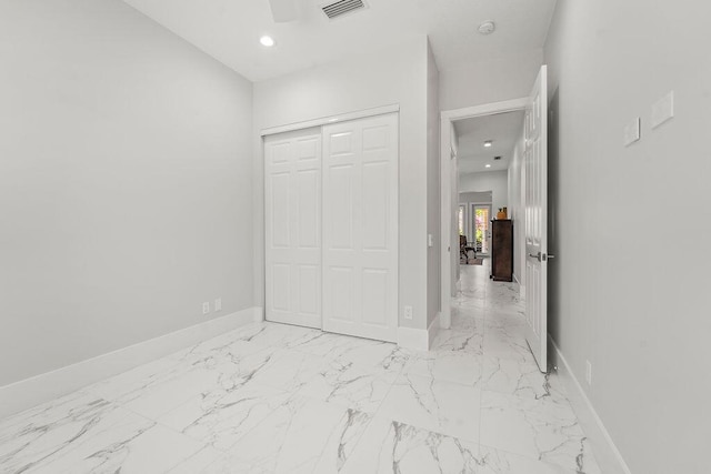 3352 SE Cascadia Way, Hobe Sound, FL 33455 - unfurnished bedroom with visible vents, marble finish floor, baseboards, and a closet