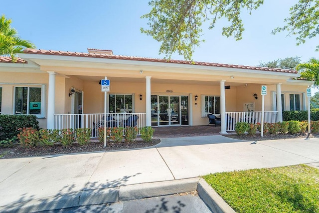 3352 SE Cascadia Way, Hobe Sound, FL 33455 - exterior space featuring stucco siding and covered porch