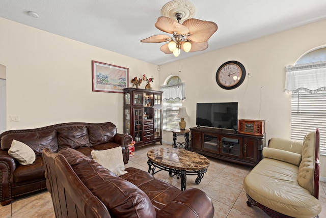living room featuring a ceiling fan and light tile patterned floors