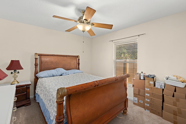 carpeted bedroom with baseboards and a ceiling fan