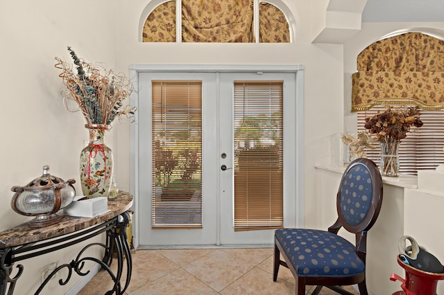 doorway to outside featuring light tile patterned flooring and french doors