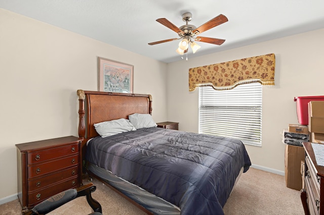 carpeted bedroom with baseboards and a ceiling fan