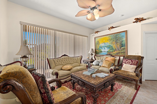 living area with tile patterned floors and a ceiling fan