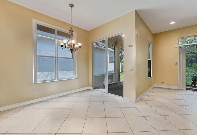 7562 Starfish Reef Ln, Lake Worth, FL 33467 - empty room featuring a chandelier, baseboards, and light tile patterned floors