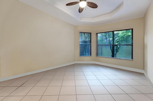 7562 Starfish Reef Ln, Lake Worth, FL 33467 - unfurnished room with a ceiling fan, baseboards, light tile patterned floors, and a tray ceiling
