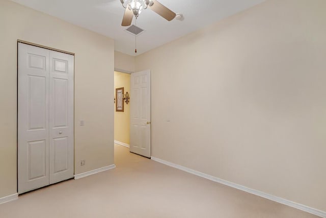 7562 Starfish Reef Ln, Lake Worth, FL 33467 - unfurnished bedroom with light colored carpet, baseboards, a ceiling fan, and a closet