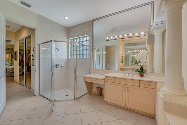 7562 Starfish Reef Ln, Lake Worth, FL 33467 - bathroom featuring decorative columns, a stall shower, vanity, and tile patterned floors