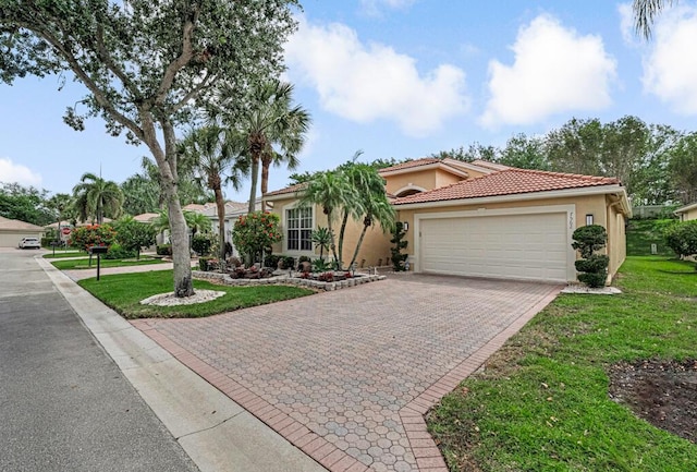 7562 Starfish Reef Ln, Lake Worth, FL 33467 - mediterranean / spanish-style home featuring stucco siding, an attached garage, decorative driveway, a front yard, and a tiled roof