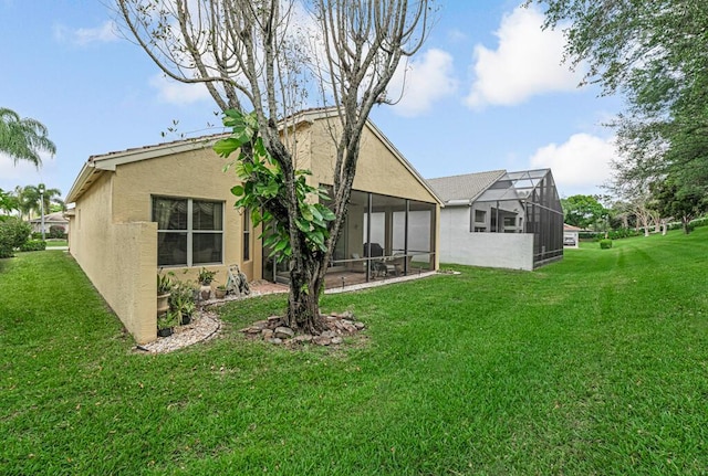7562 Starfish Reef Ln, Lake Worth, FL 33467 - rear view of property with a lawn, stucco siding, and a sunroom