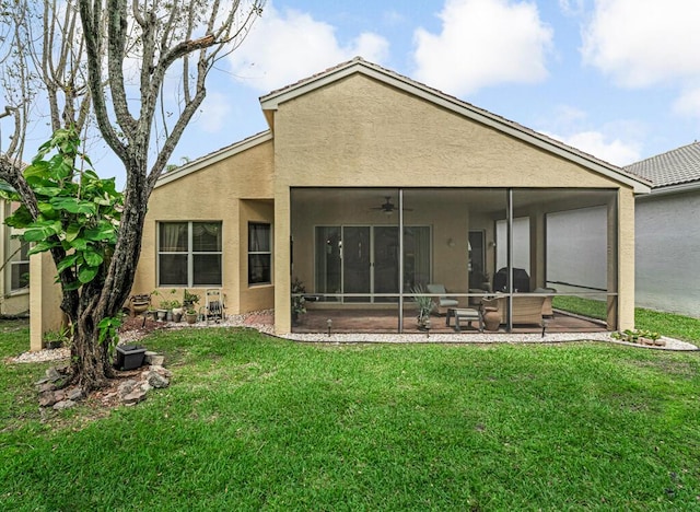 7562 Starfish Reef Ln, Lake Worth, FL 33467 - back of house with ceiling fan, stucco siding, a lawn, and a patio area