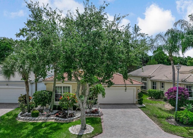 7562 Starfish Reef Ln, Lake Worth, FL 33467 - view of front of house with stucco siding, a tile roof, driveway, and an attached garage