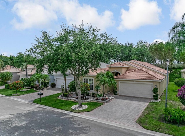 7562 Starfish Reef Ln, Lake Worth, FL 33467 - view of front facade featuring stucco siding, decorative driveway, an attached garage, a front lawn, and a tile roof