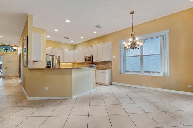 7562 Starfish Reef Ln, Lake Worth, FL 33467 - kitchen featuring stainless steel appliances, tasteful backsplash, stone countertops, white cabinets, and recessed lighting