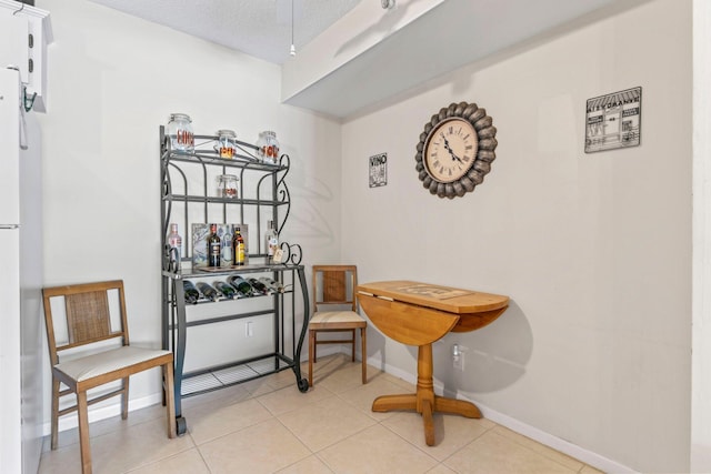 interior space featuring baseboards and light tile patterned floors