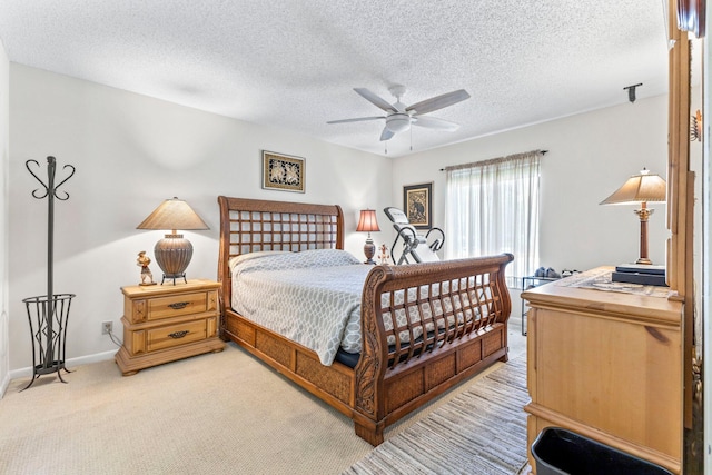bedroom featuring baseboards, carpet flooring, a textured ceiling, and ceiling fan