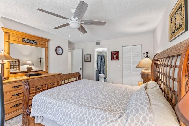 bedroom with ceiling fan, a textured ceiling, visible vents, a closet, and ensuite bathroom
