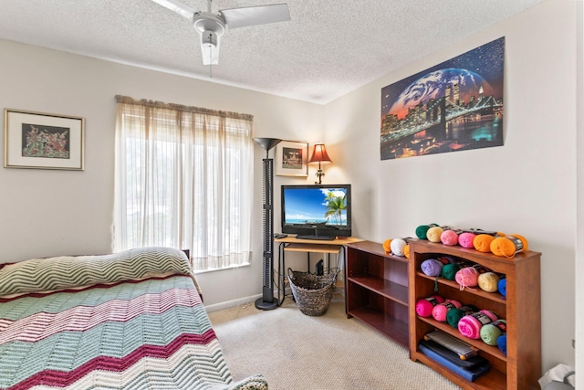 carpeted bedroom with baseboards, a textured ceiling, and ceiling fan