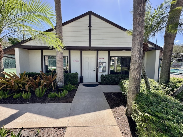 view of front facade featuring fence and stucco siding