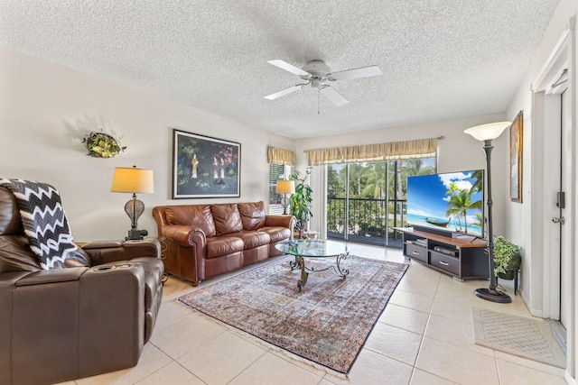 living area featuring a textured ceiling, ceiling fan, and light tile patterned floors