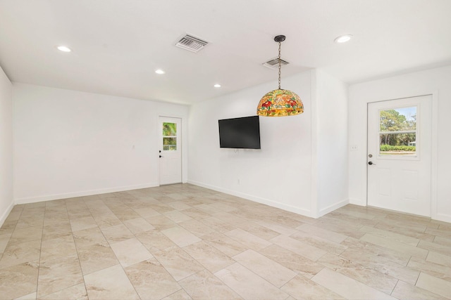 spare room featuring plenty of natural light, recessed lighting, and baseboards