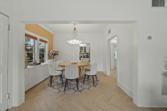 951 Selkirk St, West Palm Beach, FL 33405 - dining room with visible vents, baseboards, crown molding, and a chandelier