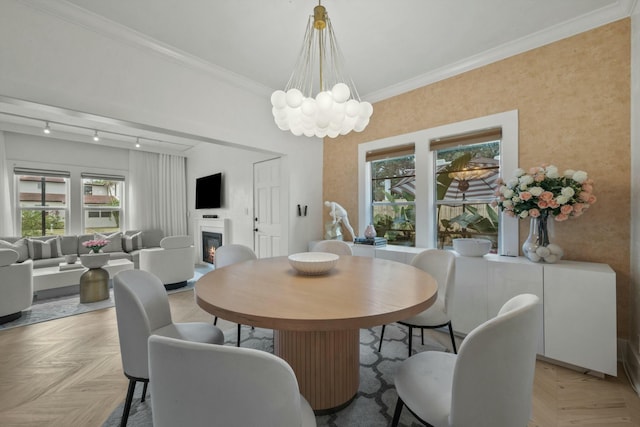 951 Selkirk St, West Palm Beach, FL 33405 - dining space featuring crown molding, a glass covered fireplace, and a chandelier