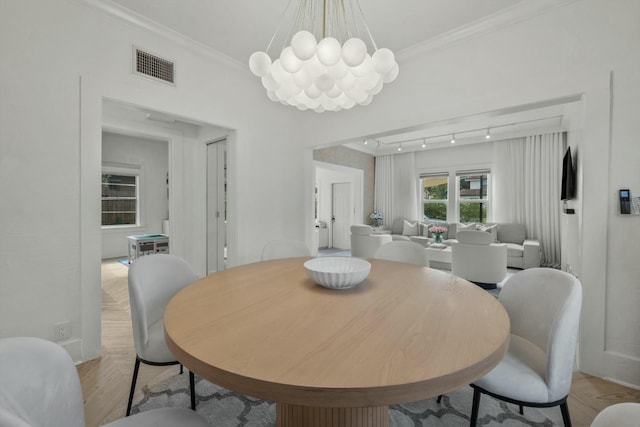 951 Selkirk St, West Palm Beach, FL 33405 - dining space with a notable chandelier, baseboards, parquet flooring, visible vents, and ornamental molding