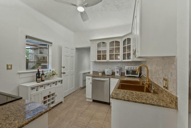 951 Selkirk St, West Palm Beach, FL 33405 - kitchen with stainless steel dishwasher, a sink, white cabinets, and tasteful backsplash