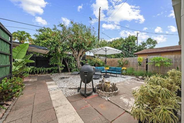 951 Selkirk St, West Palm Beach, FL 33405 - view of patio featuring a fenced backyard, outdoor lounge area, and grilling area
