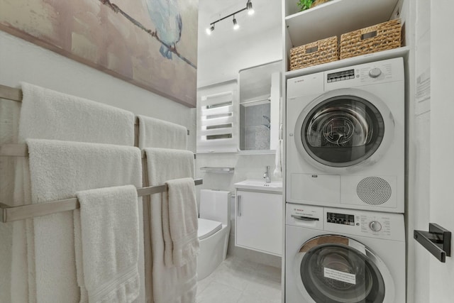 951 Selkirk St, West Palm Beach, FL 33405 - laundry room with stacked washer / drying machine, a sink, light tile patterned floors, and laundry area