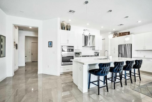 12170 N Baypoint Cir, Parkland, FL 33076 - kitchen with a sink, wall chimney range hood, stainless steel appliances, and visible vents