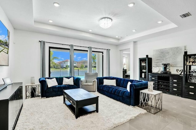 12170 N Baypoint Cir, Parkland, FL 33076 - living area with visible vents, a wealth of natural light, and a raised ceiling